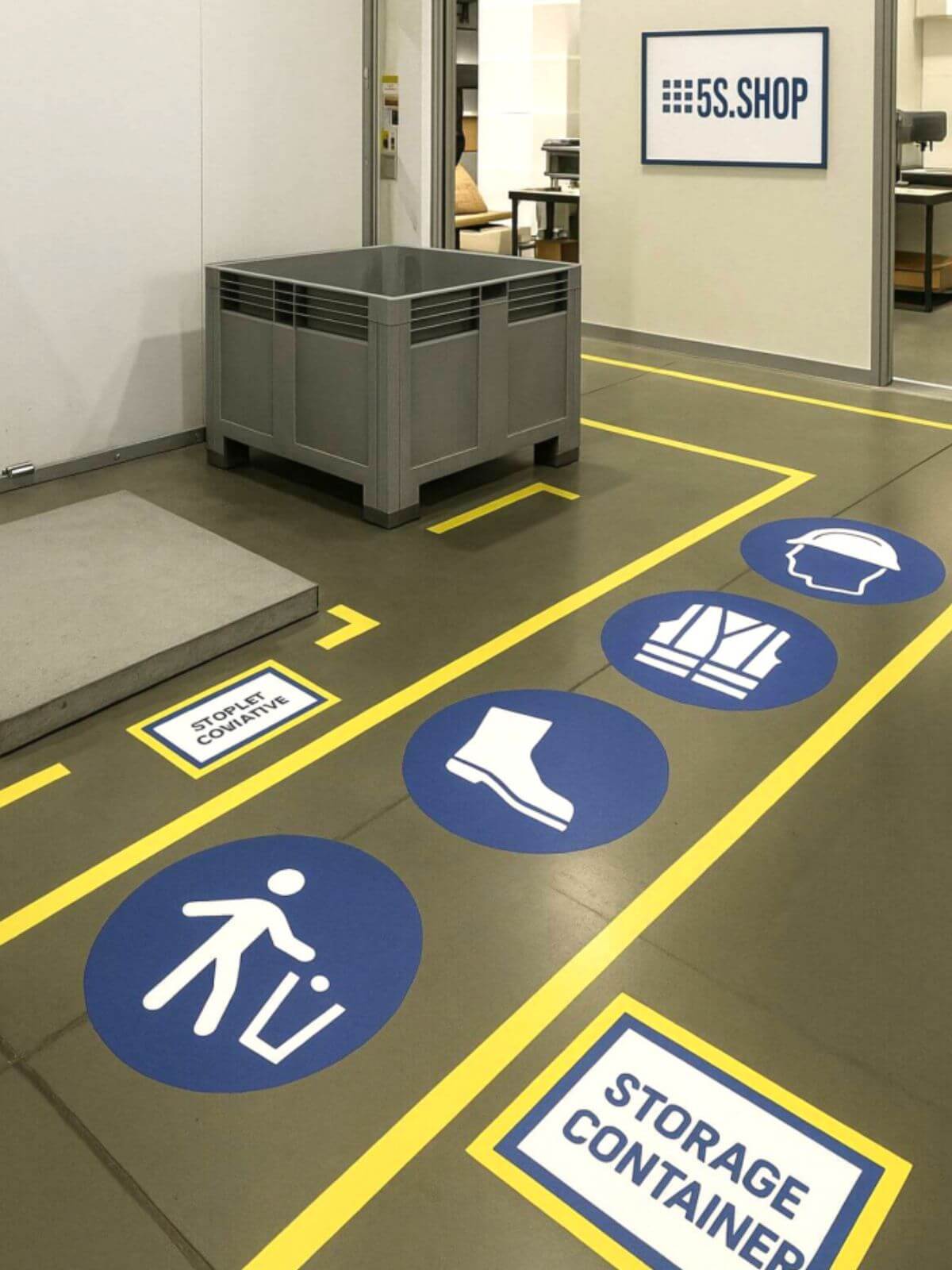 5S floor marking system in a warehouse with labeled zones for storage containers, PPE requirements including safety shoes, vests, and helmets, and clear visual management signs from 5S.SHOP.