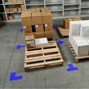 Warehouse pallet storage zones marked with blue floor tape corners to support 5S organization and visual control